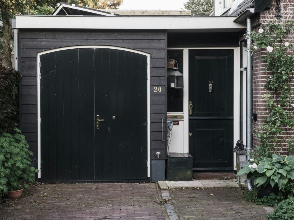 a black and white house with two black doors